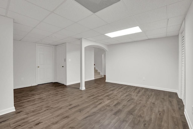 2010 Riverside Rd, Roswell, GA 30076 - below grade area with arched walkways, dark wood finished floors, a paneled ceiling, and baseboards