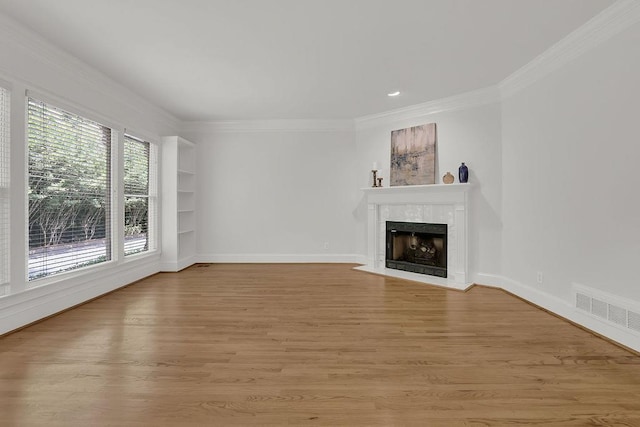 2010 Riverside Rd, Roswell, GA 30076 - unfurnished living room with ornamental molding, a tile fireplace, light wood finished floors, baseboards, and built in features