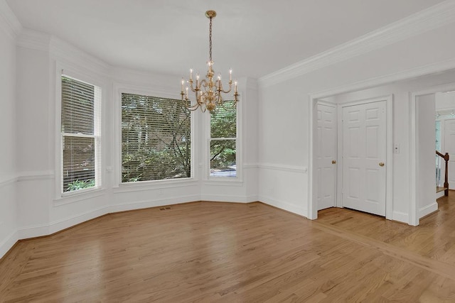 2010 Riverside Rd, Roswell, GA 30076 - unfurnished dining area featuring a chandelier, plenty of natural light, light wood-style flooring, ornamental molding, and baseboards