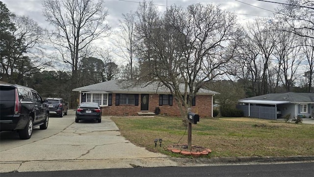 ranch-style home with crawl space, brick siding, concrete driveway, and a front yard