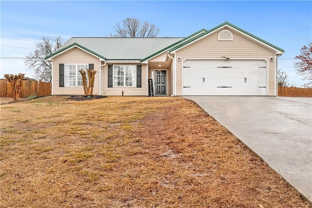 ranch-style house featuring an attached garage, fence, a front yard, metal roof, and driveway