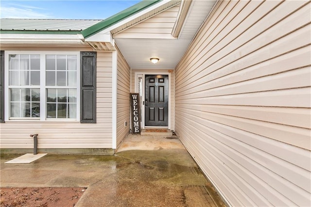 entrance to property featuring metal roof