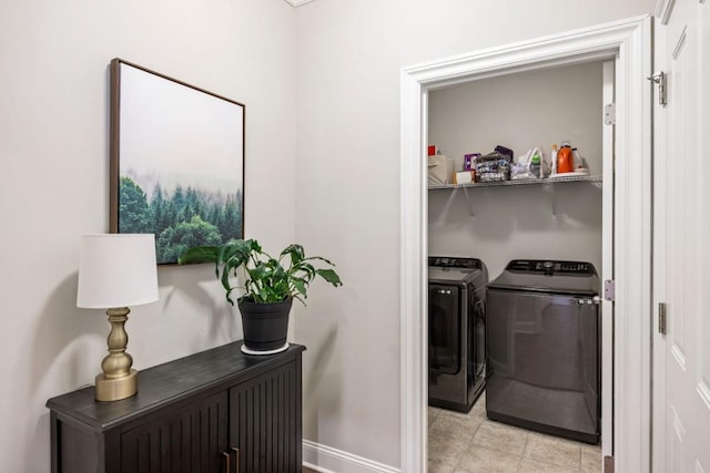 laundry room featuring washer and dryer, baseboards, and laundry area