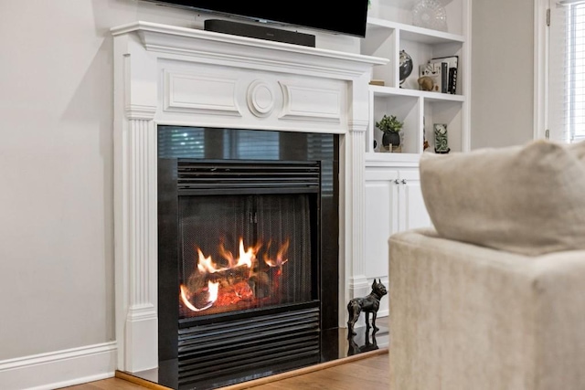 details featuring built in features and a tile fireplace