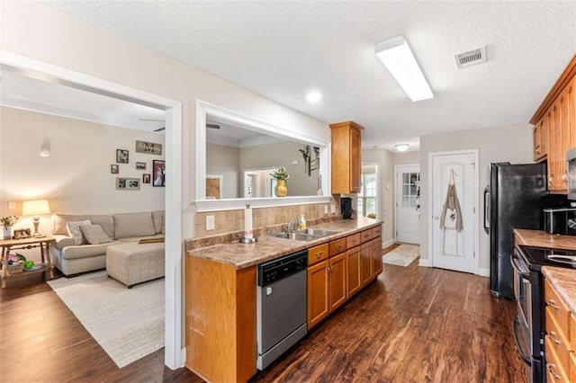 102 Blackstone Ct, Kathleen, GA 31047 - kitchen with stainless steel appliances, a sink, brown cabinets, dark wood finished floors, and a textured ceiling