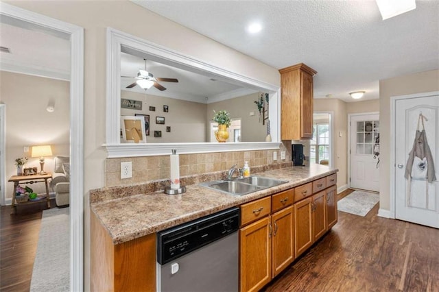 102 Blackstone Ct, Kathleen, GA 31047 - kitchen featuring stainless steel dishwasher, a sink, dark wood-style flooring, backsplash, and light countertops