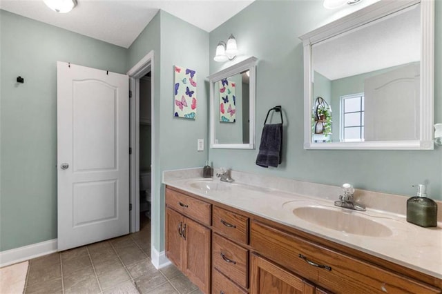 102 Blackstone Ct, Kathleen, GA 31047 - full bathroom featuring double vanity, toilet, baseboards, and tile patterned flooring