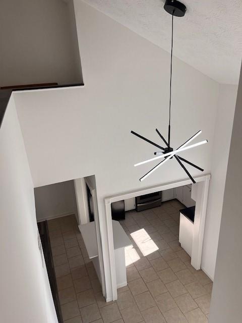 interior space featuring a textured ceiling and a notable chandelier