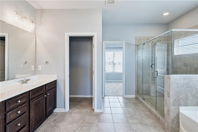 full bathroom featuring a tub to relax in, tile patterned flooring, visible vents, vanity, and a stall shower