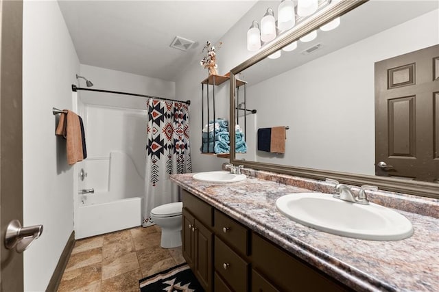 5995 Wellington Ave, Gainesville, GA 30506 - bathroom with double vanity, toilet, baseboards, stone finish floors, and shower / bathtub combination with curtain