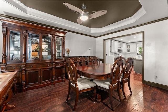 5995 Wellington Ave, Gainesville, GA 30506 - dining area featuring a tray ceiling, a ceiling fan, crown molding, dark wood-type flooring, and baseboards