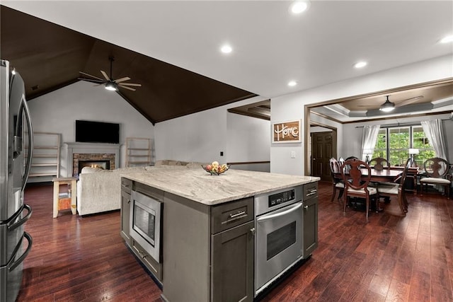 5995 Wellington Ave, Gainesville, GA 30506 - kitchen featuring ceiling fan, stainless steel appliances, a warm lit fireplace, open floor plan, and recessed lighting