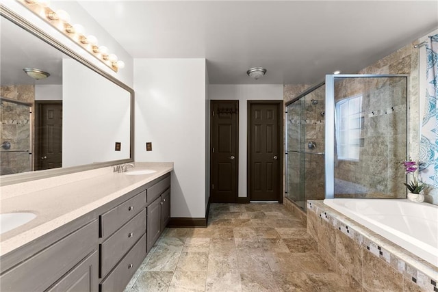 5995 Wellington Ave, Gainesville, GA 30506 - bathroom with a bath, a stall shower, double vanity, and baseboards