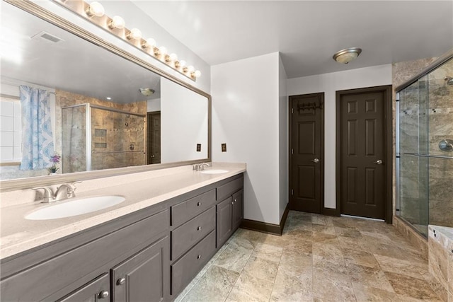 5995 Wellington Ave, Gainesville, GA 30506 - bathroom featuring double vanity, a shower stall, baseboards, and stone finish flooring