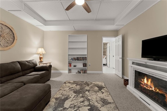 5995 Wellington Ave, Gainesville, GA 30506 - carpeted living room with baseboards, ceiling fan, and a lit fireplace