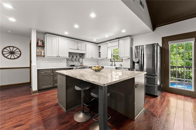 5995 Wellington Ave, Gainesville, GA 30506 - kitchen featuring stainless steel appliances, white cabinetry, a kitchen breakfast bar, ceiling fan, and a sink