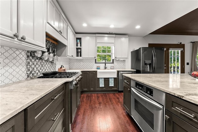 5995 Wellington Ave, Gainesville, GA 30506 - kitchen with stainless steel appliances, a sink, white cabinets, dark wood finished floors, and light stone counters
