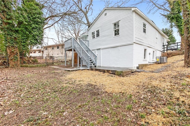 back of house with central AC and a deck