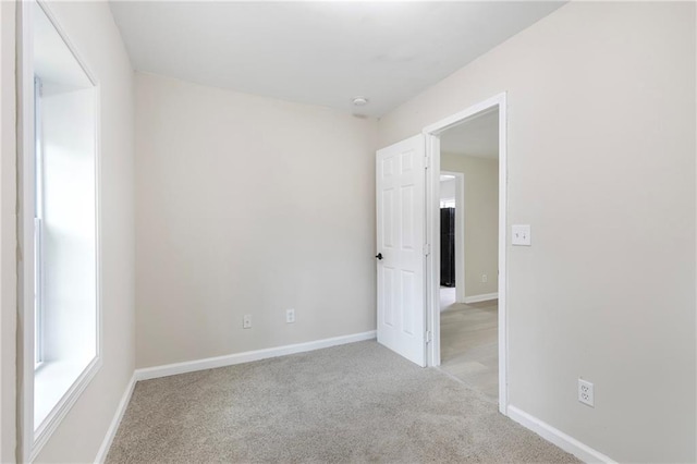 spare room with light colored carpet