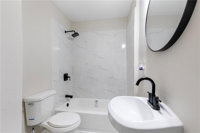 full bathroom featuring toilet, tiled shower / bath combo, and sink