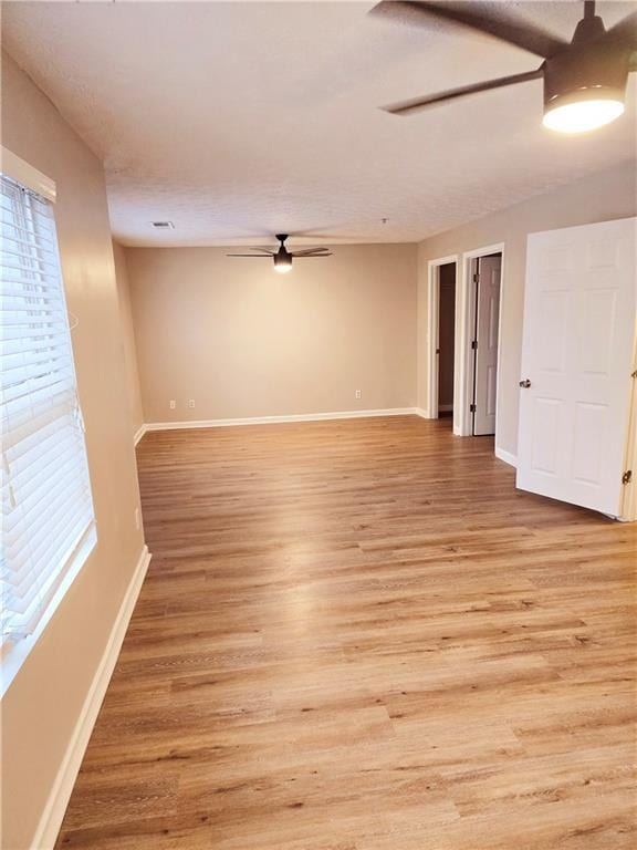 spare room featuring ceiling fan and light wood-type flooring