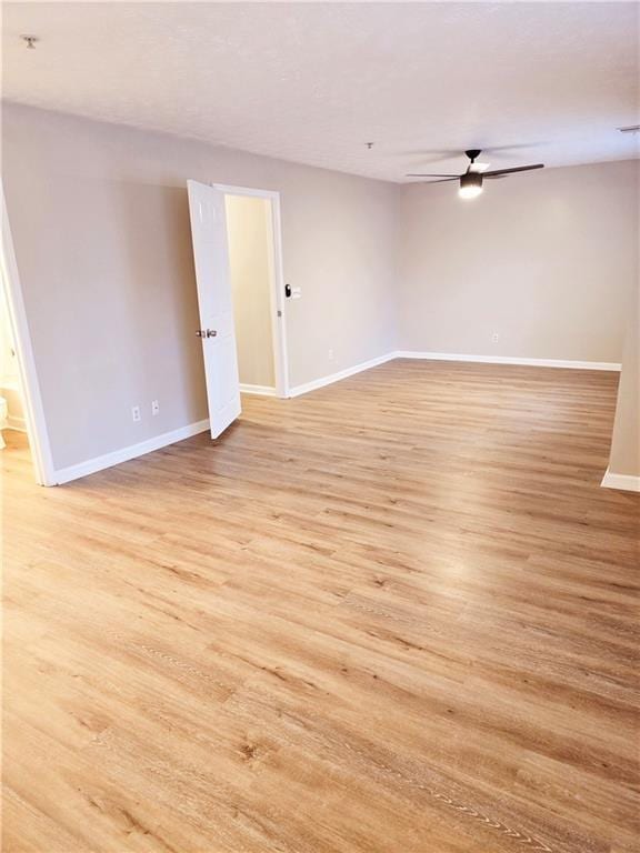 unfurnished room with light hardwood / wood-style floors and ceiling fan