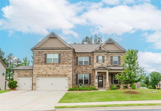 72 Whistling Dr, Jefferson, GA 30549 - craftsman-style house featuring a front lawn, driveway, brick siding, and a garage