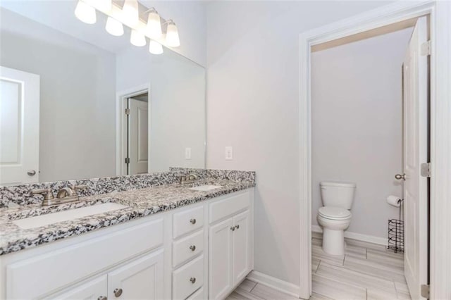 72 Whistling Dr, Jefferson, GA 30549 - bathroom with double vanity, toilet, and baseboards