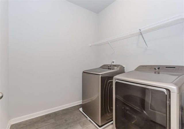 72 Whistling Dr, Jefferson, GA 30549 - laundry area featuring washer and clothes dryer, light wood finished floors, and baseboards
