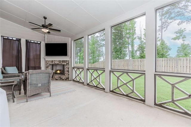 72 Whistling Dr, Jefferson, GA 30549 - sunroom / solarium featuring a brick fireplace, ceiling fan, lofted ceiling, and plenty of natural light