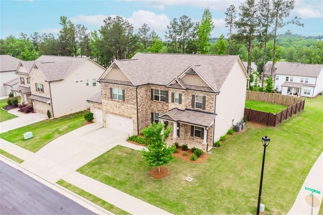 72 Whistling Dr, Jefferson, GA 30549 - craftsman-style house featuring an attached garage, concrete driveway, a residential view, covered porch, and stone siding