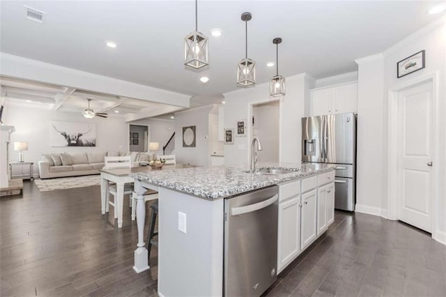 72 Whistling Dr, Jefferson, GA 30549 - kitchen featuring stainless steel appliances, a sink, dark wood-style flooring, open floor plan, and white cabinetry