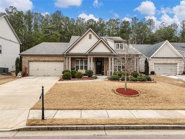 craftsman-style home featuring central AC and a garage