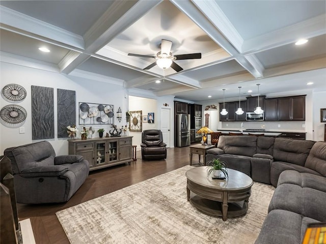 living room featuring coffered ceiling, crown molding, dark hardwood / wood-style flooring, beamed ceiling, and ceiling fan