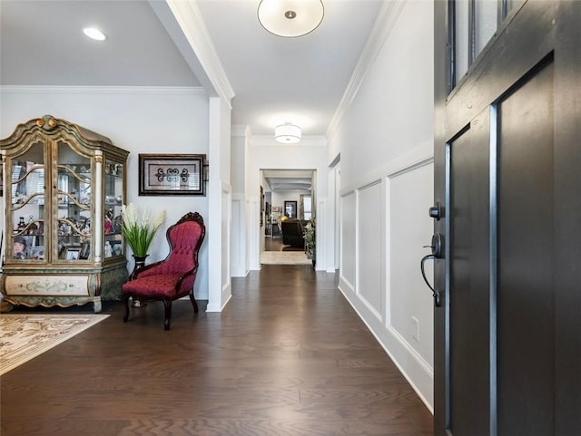 entryway with ornamental molding and dark hardwood / wood-style flooring