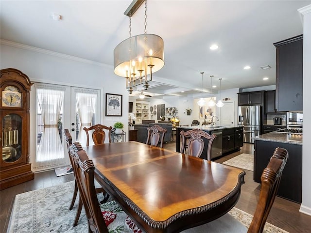 dining space with crown molding, sink, dark hardwood / wood-style flooring, and french doors