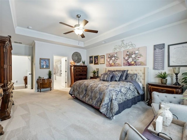 bedroom featuring connected bathroom, crown molding, light carpet, a raised ceiling, and ceiling fan