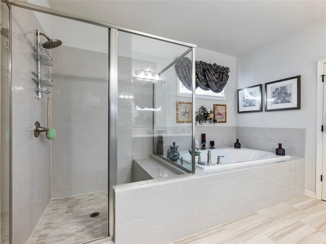 bathroom featuring tile patterned floors and separate shower and tub