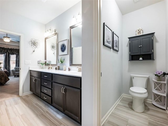 bathroom featuring ceiling fan, vanity, and toilet