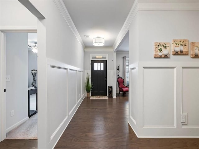 entrance foyer with dark hardwood / wood-style flooring and ornamental molding