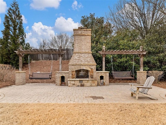 view of patio / terrace featuring an outdoor stone fireplace