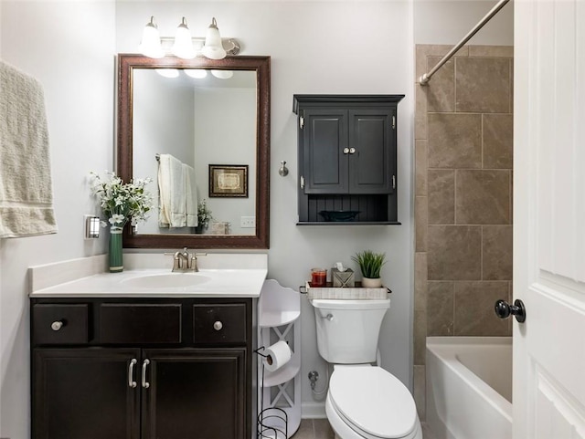 full bathroom with vanity, tiled shower / bath, and toilet