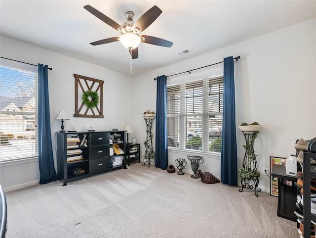 misc room with ceiling fan, plenty of natural light, and light carpet