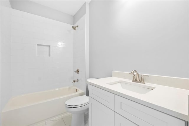 full bathroom featuring toilet, vanity, tile patterned floors, and tiled shower / bath