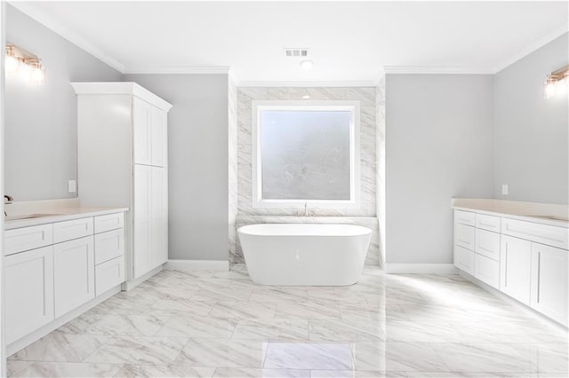 bathroom featuring ornamental molding, a bathing tub, and vanity