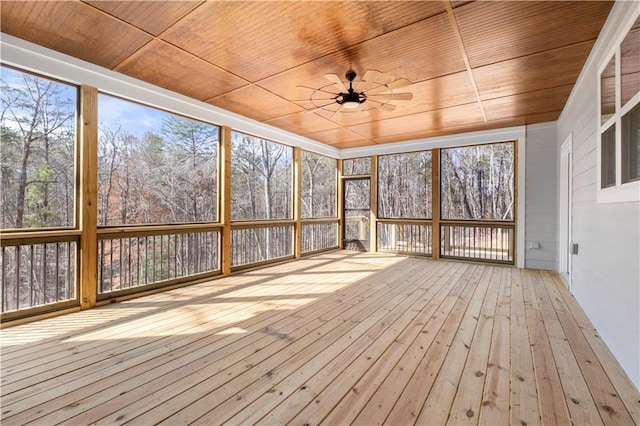 unfurnished sunroom with ceiling fan and wooden ceiling