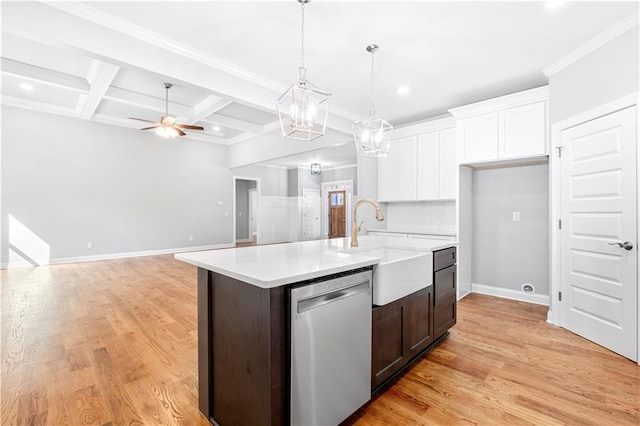 kitchen with white cabinets, beamed ceiling, stainless steel dishwasher, a center island with sink, and coffered ceiling