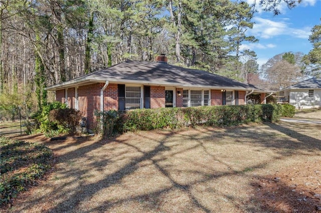 single story home featuring brick siding and a chimney