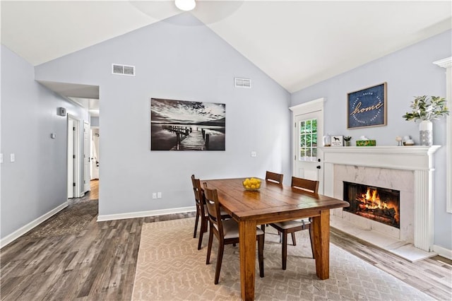 115 Donna Dr, Dawsonville, GA 30534 - dining space featuring wood finished floors, a fireplace, high vaulted ceiling, and a ceiling fan