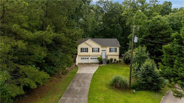 115 Donna Dr, Dawsonville, GA 30534 - view of front facade featuring concrete driveway, a garage, a front lawn, and a wooded view